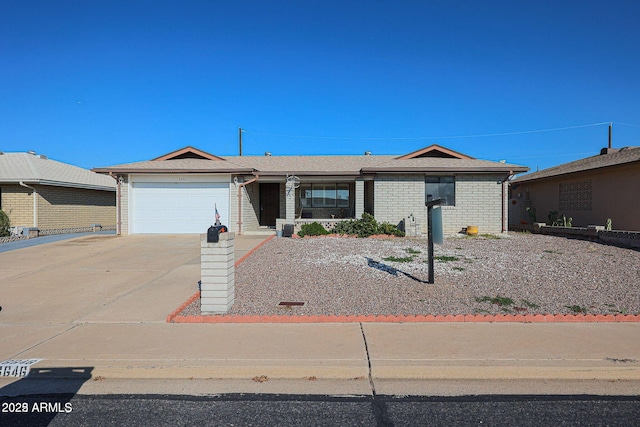 ranch-style house featuring a garage, brick siding, and driveway