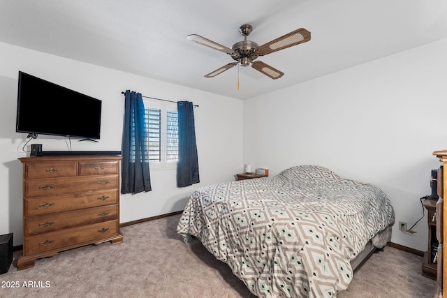 carpeted bedroom with a ceiling fan and baseboards