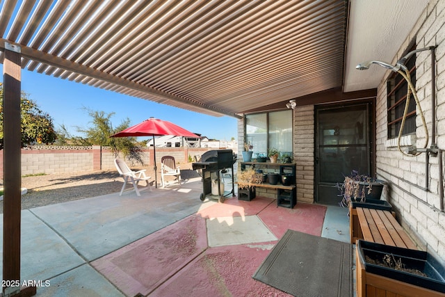 view of patio / terrace featuring a fenced backyard, a pergola, and area for grilling