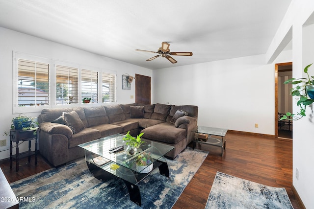 living area featuring ceiling fan, baseboards, and wood finished floors