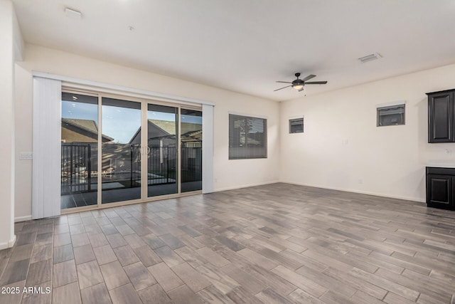 unfurnished living room featuring ceiling fan and wood-type flooring