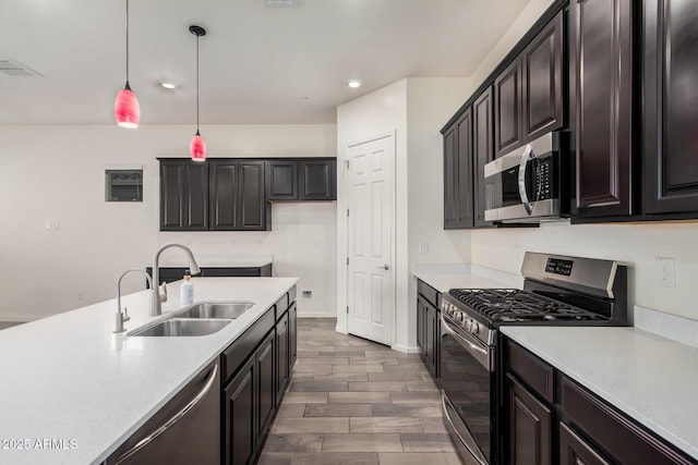 kitchen featuring sink, hanging light fixtures, and stainless steel appliances