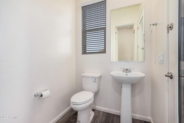 bathroom with hardwood / wood-style flooring, sink, and toilet