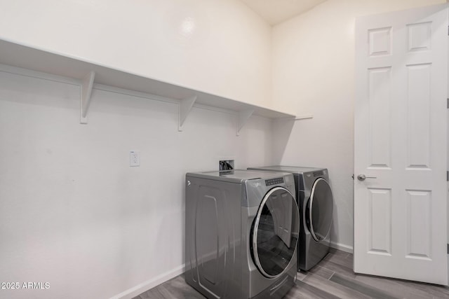 laundry area featuring hardwood / wood-style flooring and separate washer and dryer