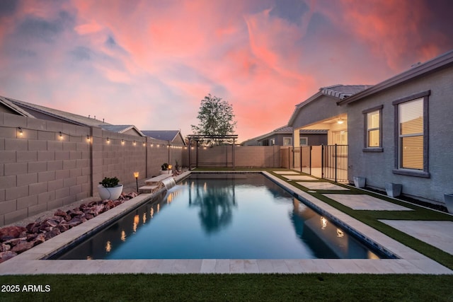 pool at dusk with pool water feature