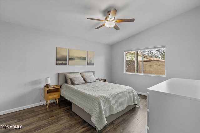 bedroom featuring lofted ceiling, dark wood-style floors, baseboards, and ceiling fan