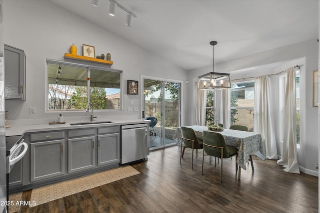 dining space featuring dark wood-style floors, a chandelier, a healthy amount of sunlight, and lofted ceiling