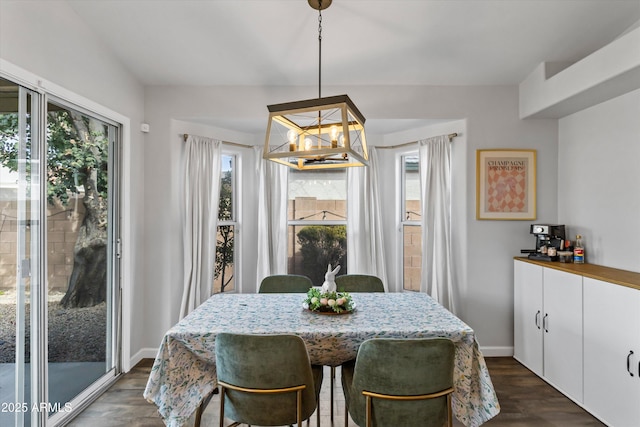 dining room with dark wood-style floors, baseboards, and a chandelier