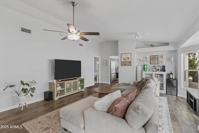 living room featuring visible vents, a dry bar, wood finished floors, and vaulted ceiling