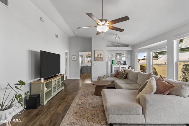 living area featuring dark wood-type flooring, a ceiling fan, visible vents, and lofted ceiling