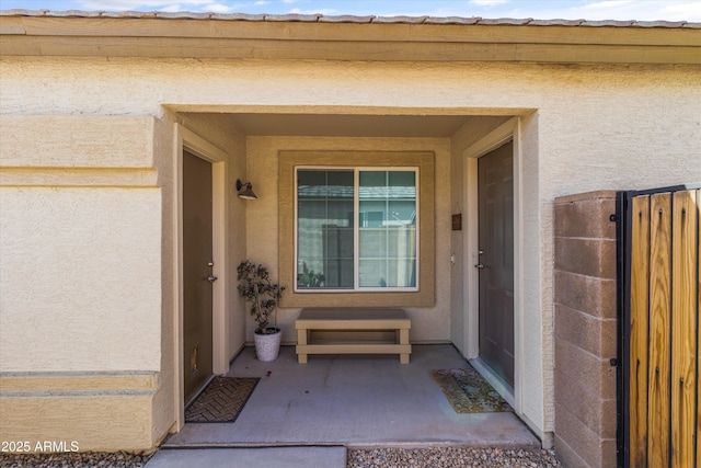 doorway to property with stucco siding