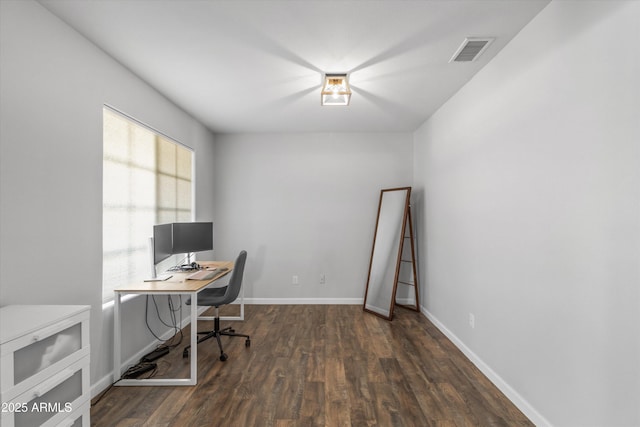 office area with visible vents, baseboards, and wood finished floors