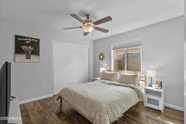 bedroom featuring a closet, baseboards, and dark wood-style floors