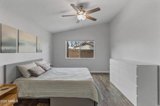 bedroom with a ceiling fan, vaulted ceiling, dark wood-style floors, and baseboards