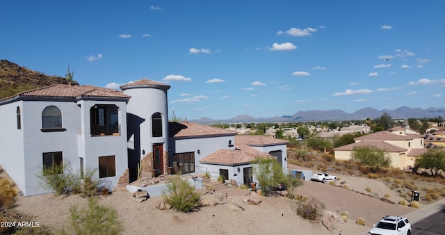 back of house with a mountain view