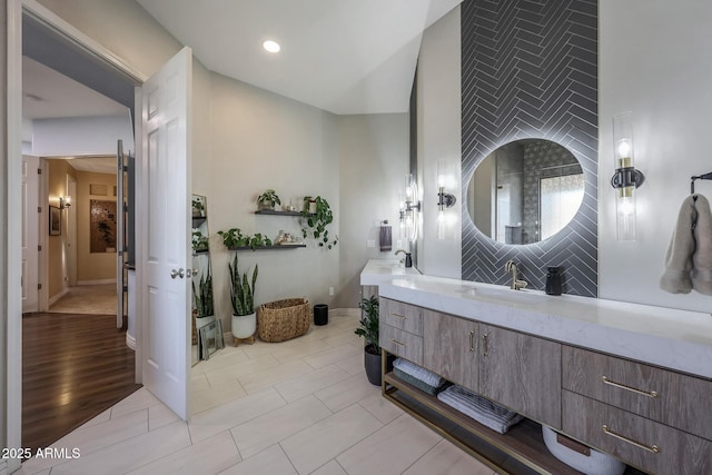bathroom with tasteful backsplash, recessed lighting, vanity, and baseboards