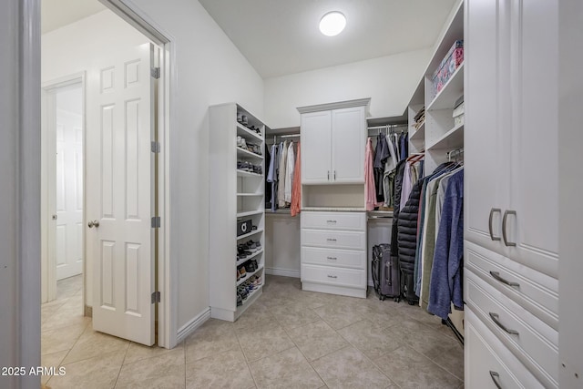 spacious closet featuring light tile patterned floors