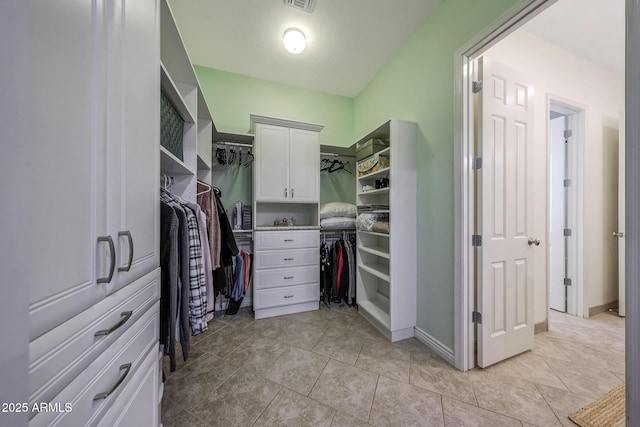 walk in closet with visible vents and light tile patterned floors