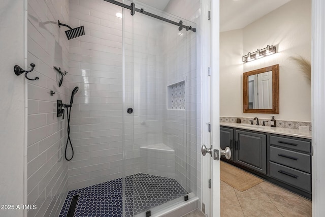 bathroom with a stall shower, tile patterned flooring, and vanity
