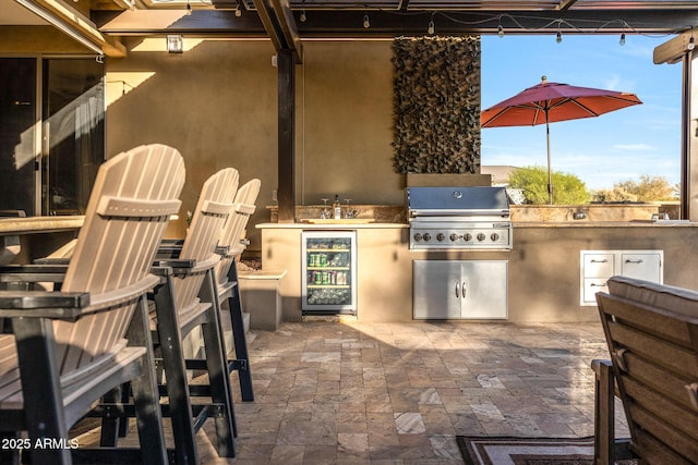 view of patio with a sink, wine cooler, grilling area, and exterior kitchen