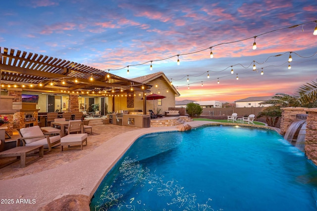 view of pool featuring a patio, an outdoor kitchen, fence, outdoor dry bar, and a fenced in pool