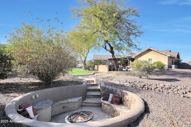view of yard with a fire pit
