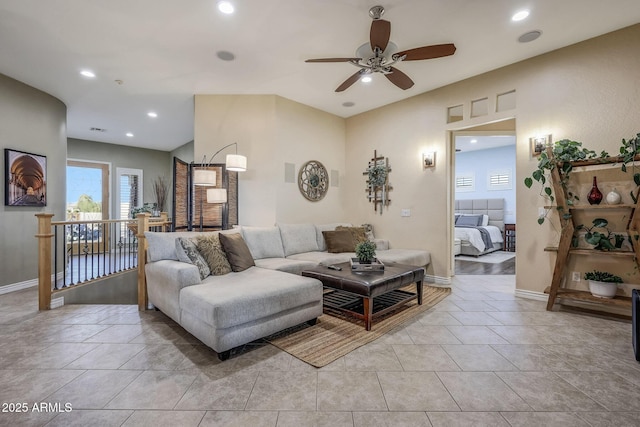 living room featuring light tile patterned flooring, baseboards, a ceiling fan, and recessed lighting