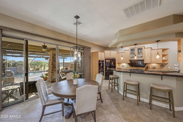 dining room featuring ceiling fan, visible vents, and light tile patterned flooring