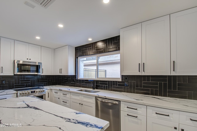 kitchen featuring white cabinetry, appliances with stainless steel finishes, and sink