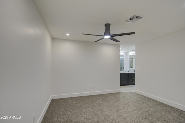 carpeted spare room with ceiling fan