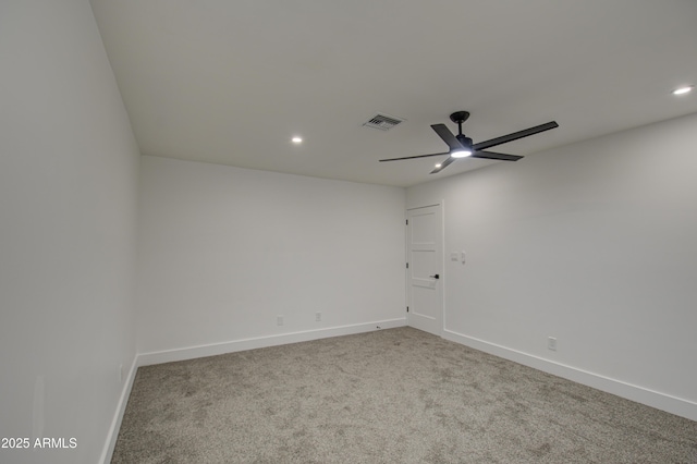 carpeted spare room with ceiling fan