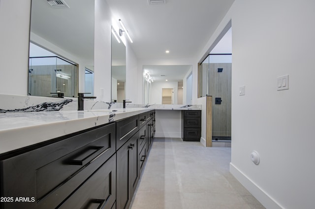 bathroom featuring vanity and a shower with shower door