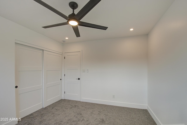 unfurnished bedroom featuring ceiling fan, carpet flooring, and a closet