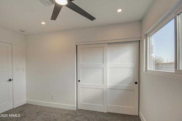 unfurnished bedroom featuring a closet, ceiling fan, and carpet