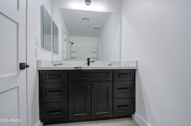 bathroom with vanity and walk in shower