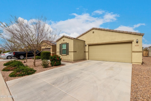 mediterranean / spanish home with driveway, a tiled roof, and stucco siding