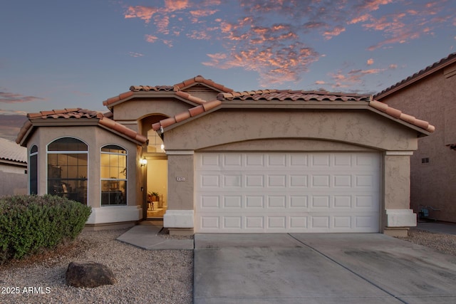 mediterranean / spanish-style house with a garage