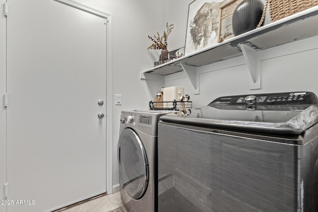 laundry room with washing machine and dryer and light tile patterned flooring