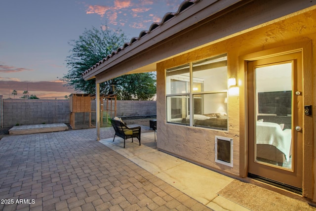 view of patio terrace at dusk