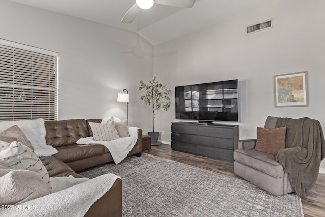 living room featuring hardwood / wood-style flooring, lofted ceiling, and ceiling fan