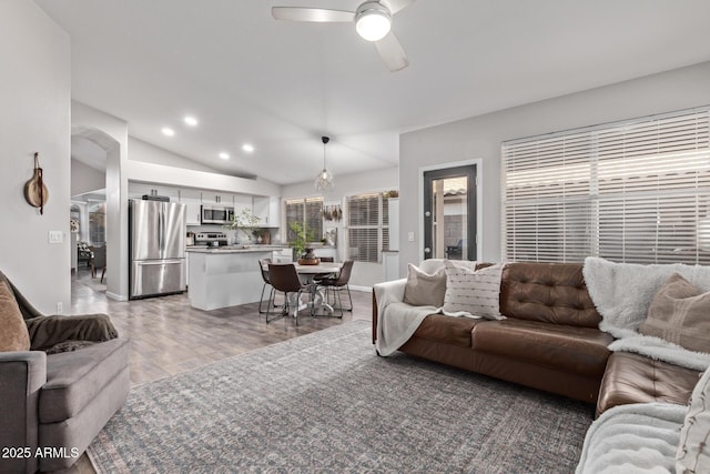 living room with lofted ceiling, hardwood / wood-style flooring, plenty of natural light, and ceiling fan