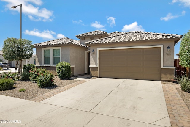 25974 W Horsham Dr, Buckeye, AZ 85396 - mediterranean / spanish house with stucco siding, an attached garage, a tile roof, and driveway