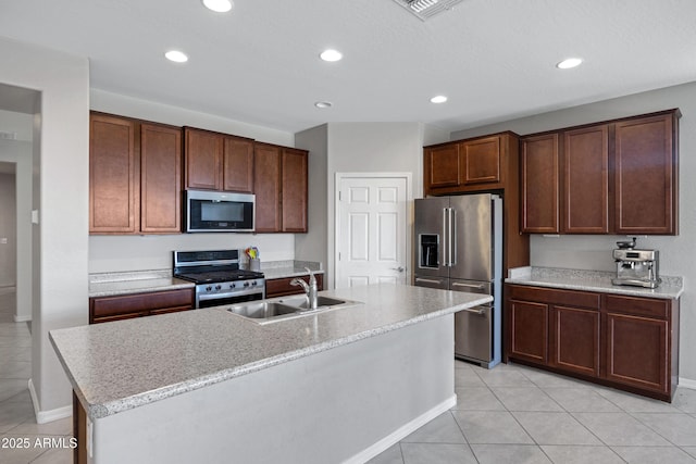 25974 W Horsham Dr, Buckeye, AZ 85396 - kitchen with stainless steel appliances, recessed lighting, light tile patterned flooring, and a kitchen island with sink