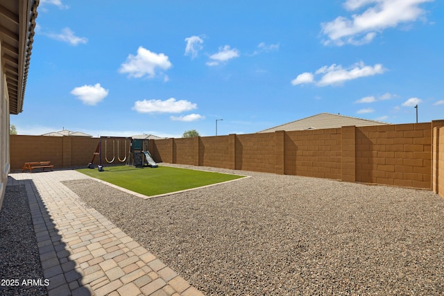 25974 W Horsham Dr, Buckeye, AZ 85396 - fenced backyard featuring a playground and a patio area