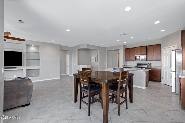 25974 W Horsham Dr, Buckeye, AZ 85396 - dining area with built in shelves, light tile patterned floors, recessed lighting, and ceiling fan