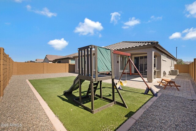 25974 W Horsham Dr, Buckeye, AZ 85396 - back of property with stucco siding, a tile roof, a patio area, a fenced backyard, and a playground
