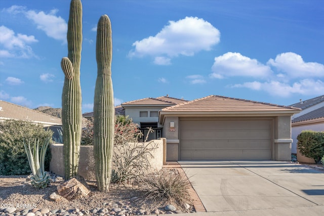 13724 N Wild Hazel Ln, Marana, AZ 85658 - view of front of home featuring an attached garage, a tiled roof, driveway, and stucco siding