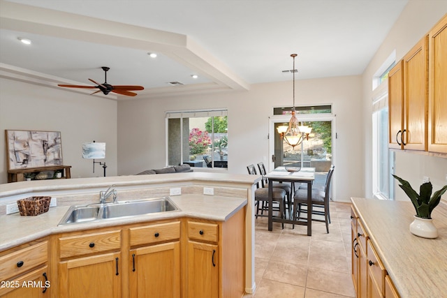 13724 N Wild Hazel Ln, Marana, AZ 85658 - kitchen featuring light tile patterned floors, light countertops, a sink, and hanging light fixtures