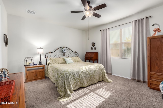 bedroom with ceiling fan and light colored carpet