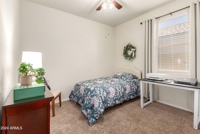 bedroom with ceiling fan and light carpet